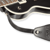 CFG Cable Free Guitar Gravity Gap strap extender installed between a guitar strap and strap button, adding extra length for lower playing positions while maintaining a secure connection