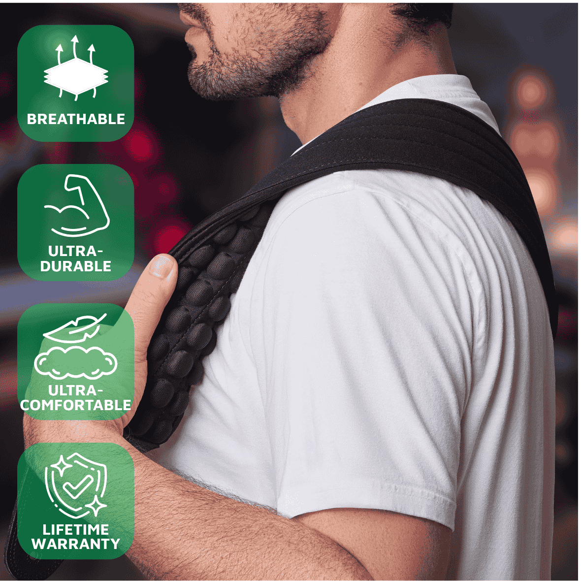 Person wearing a black guitar bass strap belt with green feature icons and text on a blurred background ZERO-G Pro guitar and bass strap by CFG Cable Free Guitar neoprene padded comfort no pain strap belt weight high quality high-end aircell cushion 3d