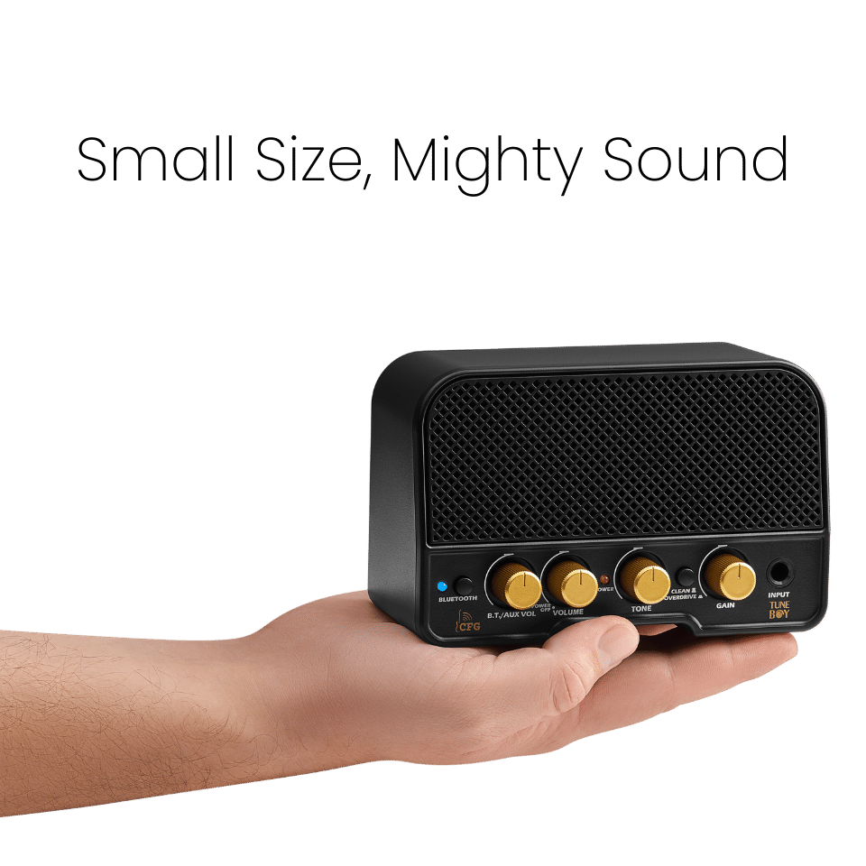 Hand holding the compact TuneBoy mini amplifier, highlighting its portable size and powerful sound capabilities.